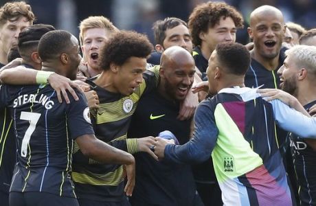 Manchester City players celebrate at the end of the English Premier League soccer match between Brighton and Manchester City at the AMEX Stadium in Brighton, England, Sunday, May 12, 2019. Manchester City defeated Brighton 4-1 to win the championship. (AP Photo/Frank Augstein)