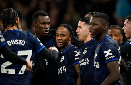 Chelsea's Raheem Sterling, center, celebrates after scoring the opening goal during the English Premier League soccer match between Manchester City and Chelsea at the Etihad stadium in Manchester, England, Saturday, Feb. 17, 2024. (AP Photo/Dave Thompson)