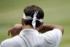 Switzerland's Roger Federer wipes his face during the men's singles final match against Serbia's Novak Djokovic at the Wimbledon Tennis Championships in London, Sunday, July 14, 2019. (AP Photo/Ben Curtis)