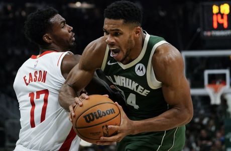 Milwaukee Bucks' Giannis Antetokounmpo is fouled by Houston Rockets' Tari Eason during the second half of an NBA basketball game Saturday, Oct. 22, 2022, in Milwaukee. (AP Photo/Morry Gash)