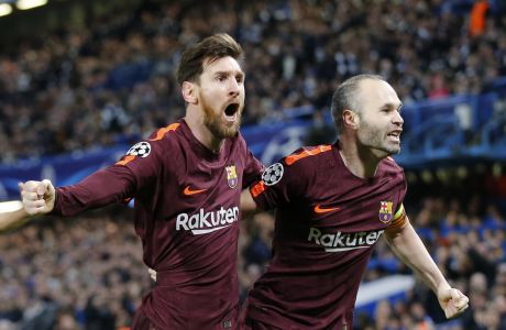 Barcelona's Lionel Messi celebrates with Andres Iniesta scoring his side's first goal during a Champions League round of sixteen first leg soccer match between FC Barcelona and Chelsea at Stamford Bridge stadium in London, Tuesday, Feb. 20, 2018. (AP Photo/Alastair Grant)